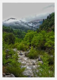 Scenic view of mountains against cloudy sky