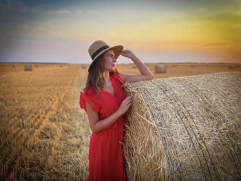 Woman standing on field against sky