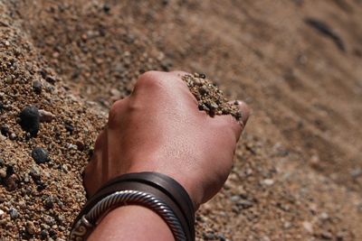 Midsection of person hand on land