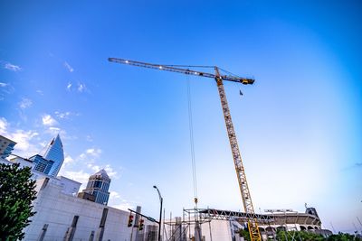 Low angle view of crane against clear sky