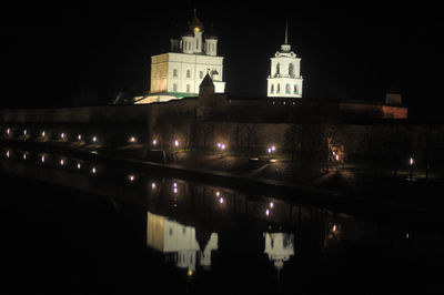 Illuminated building against sky at night