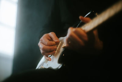 Close-up of hand playing guitar 