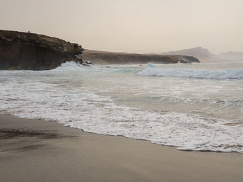 Scenic view of beach against clear sky