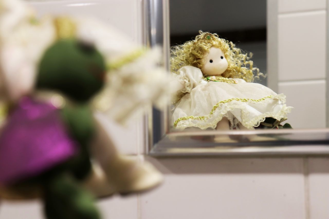 toy, indoors, childhood, selective focus, child, doll, representation, floristry, flower, human representation, domestic room, yellow, home interior, stuffed toy, celebration, dress