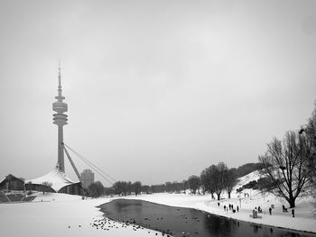 View of communications tower and buildings against sky