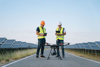 Man working on road against sky