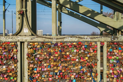 Low angle view of padlocks on bridge