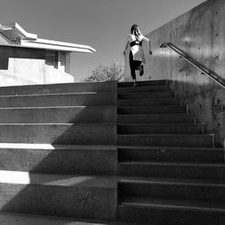 Low angle view of woman walking on stairs