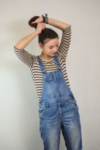 Young woman standing against white background