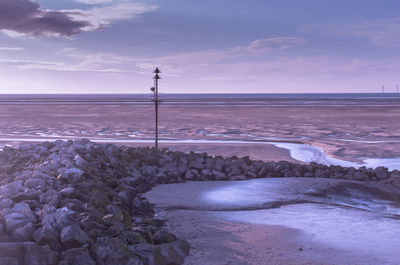 Scenic view of sea against cloudy sky