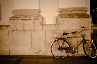 Bicycle leaning against wall