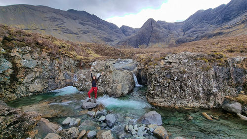 Scenic view of waterfall in mountains