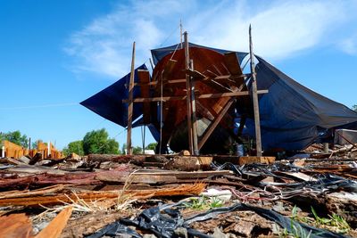 Traditional windmill on field against sky