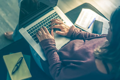 Woman working on laptop at home. female hands typing on pc keyboard. girl studying online