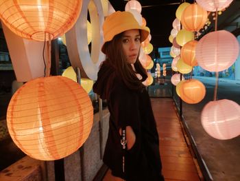 Woman looking at illuminated lantern