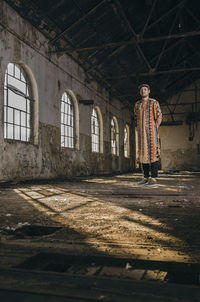 Portrait of man standing in abandoned building