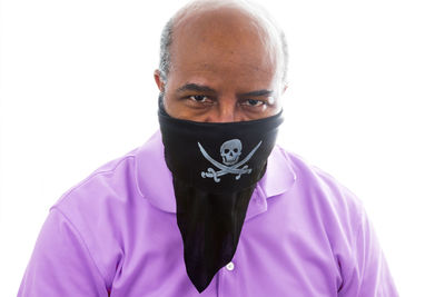 Portrait of young man standing against white background