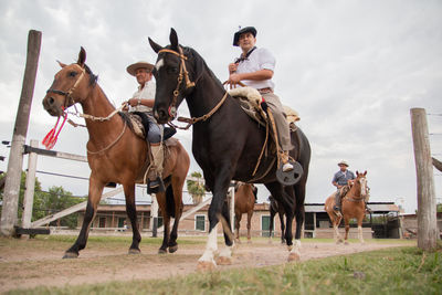 People riding horses in south america