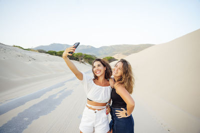 Young women with mobile phones are excited and happy