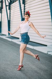 Pretty young girl in denim shorts posing and showing off her perfect figure