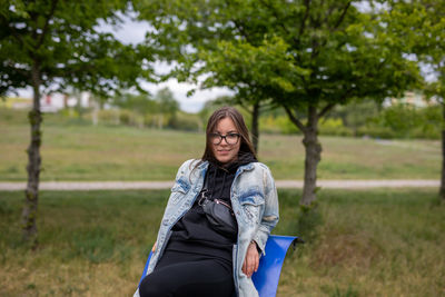 Portrait of smiling young woman on field