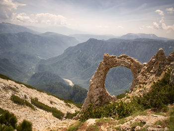 Aerial view of mountain range against cloudy sky