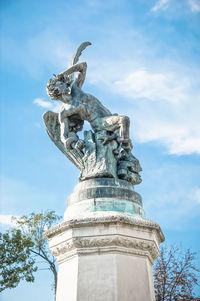Low angle view of statue against sky