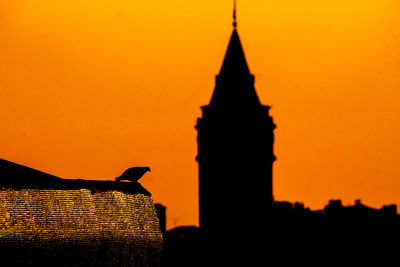 Low angle view of built structure at sunset