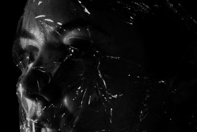 Close-up of statue against black background