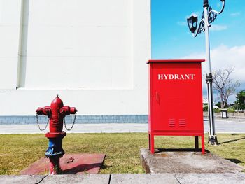 Low angle view of hydrant fire protection standing against wall of building