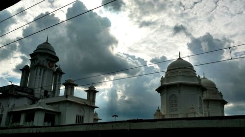 Low angle view of church against cloudy sky