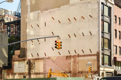 Low angle view of road signal and buildings