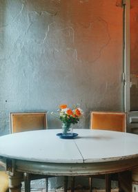 Potted plant on table against wall at restaurant