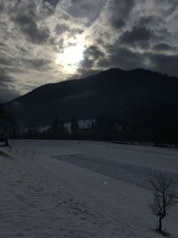 Scenic view of snowcapped mountains against sky during sunset