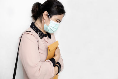 Young woman standing against white background