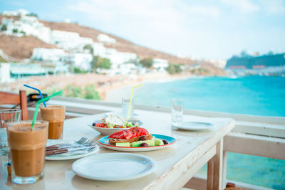 High angle view of breakfast on table at swimming pool