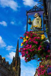 Low angle view of statue against cloudy sky