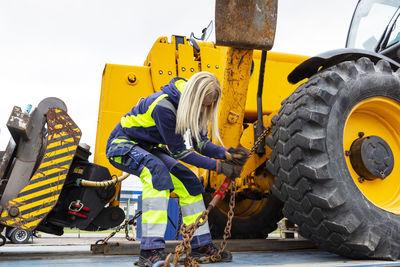 Woman working with construction vehicle