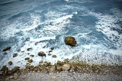 High angle view of rocks in sea