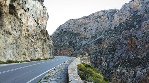 Empty road leading towards mountains