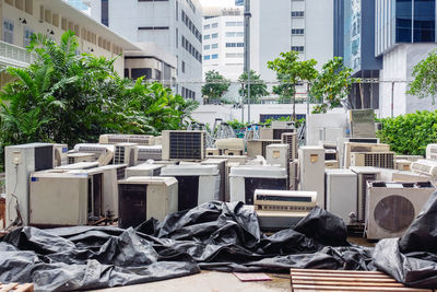 A lot of air conditioners stacked up in a pile to disposal at recycling garbage dump. 