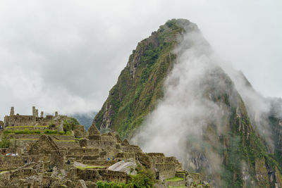 Scenic view of mountains against cloudy sky