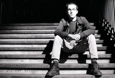 Portrait of young man sitting on bench