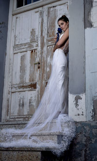 Woman standing against wall