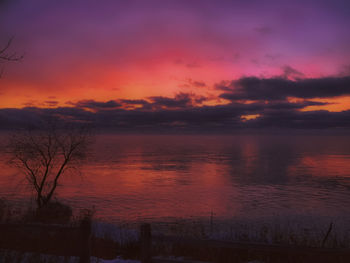 Scenic view of lake against romantic sky at sunset