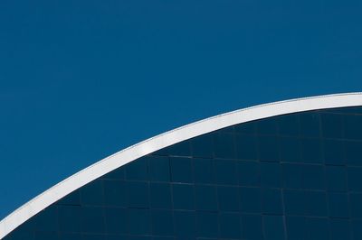 Low angle view of modern building against clear blue sky