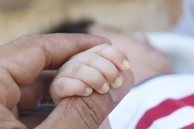 Close-up of couple holding hands