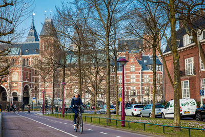 Man walking on street amidst buildings in city