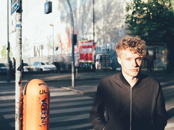 Portrait of young handsome man on standing street