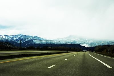 Empty road with mountains in background